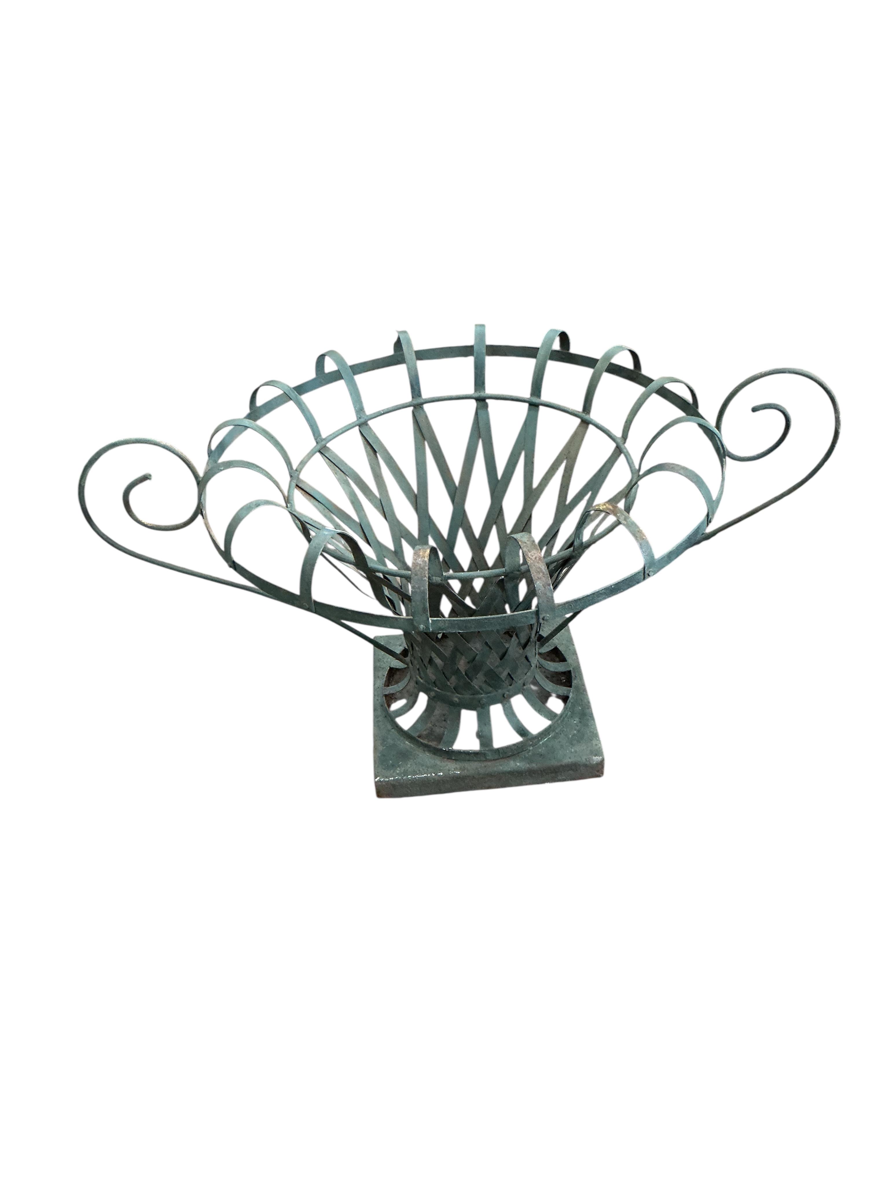 A pair of large painted wrought iron strapwork flower urns, diameter 90cm, height 44cm